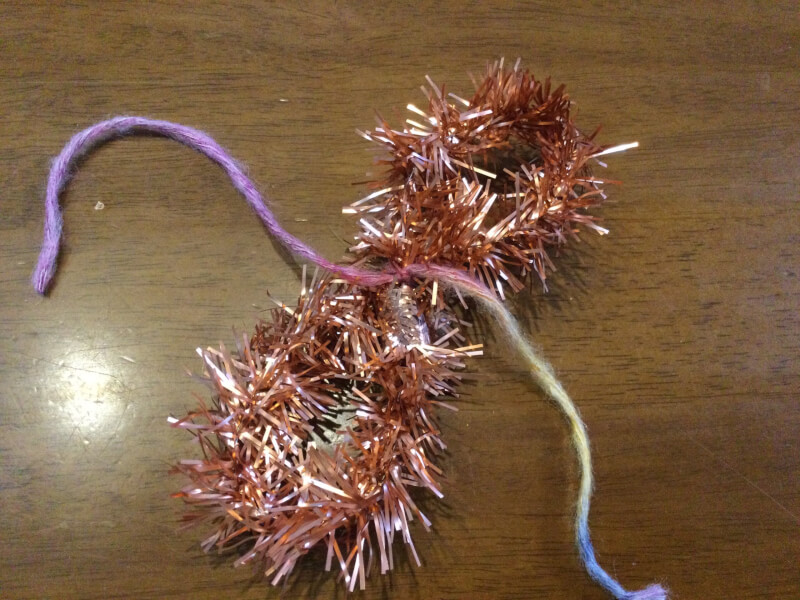 ハロウィンの製作でモールを毛糸で縛っている写真